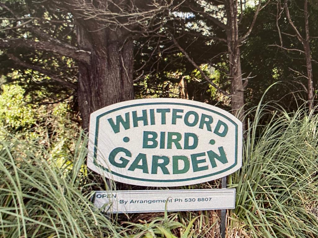 The Whitford Bird Garden sign among trees